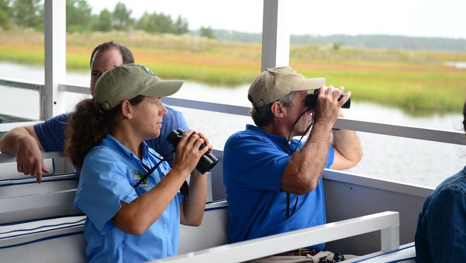 Kara Coats, Deputy Secretary- DNREC, and Governor John Carney look at wildlife along the shore during the  Cape Water Taxi Eco Tour on Wednesday, Sept. 27, 2017.