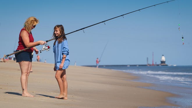 10/08/11 - Cape Henlopen, DE - sussex.outdoors - Amy Ferguson of Harbeson, DE. enjoys a nice Sunday with her daughter Lori, 11, as they enter a fishing competition at the Cape Henlopen State Park.  Parents spend time with their kids as they enjoy some outdoor activities in Cape Henlopen Saturday, Oct. 8, 2011.
The News Journal/SUCHAT PEDERSON