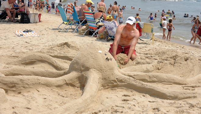 Jeff Cox of Baltimore moves sand from his octopus during the 32nd annual Delaware Seashore State Park Sandcastle Contest in 2012.