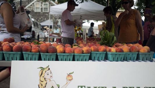 Bennett Orchards offers fresh peaches to patrons shopping the Lewes farmers market.