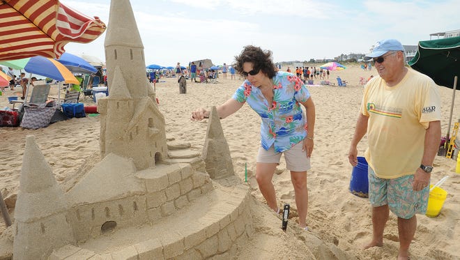 Long time Sandcastle builder Darrell O'Conner from Dewey Beach was on hand to show Barbara Dempsey from Drexel Hill, PA how to work the sand at the 38th Annual Rehoboth Beach-Dewey Beach Chamber of Commerce Sandcastle Contest was held Saturday, Sept. 10, 2016 at a new location on the south end of the beach near Funland under hot weather conditions.  Participants worked to create different castles and sculptures in the sand for judging in the late afternoon at which time trophy's ail be given out.