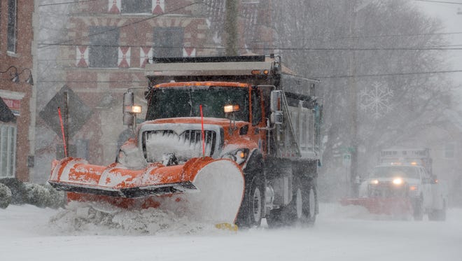 DelDot snow plows remove snow from Savannah Road in  Lewes.