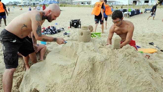 Jeff Fake and John Dundore from Lebanon, PA. work on their castle as The 38th Annual Rehoboth Beach-Dewey Beach Chamber of Commerce Sandcastle Contest was held on Saturday, Sept. 10, 2016 at a new location on the south end of the beach near Funland under hot weather conditions.  Participants worked to create different castles and sculptures in the sand for judging in the late afternoon at which time trophy's ail be given out.