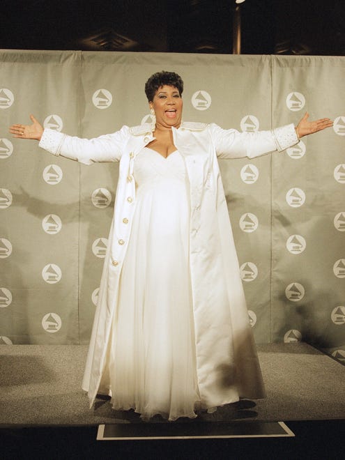Aretha Franklin gestures backstage after winning a Grammy for lifetime achievement at the 36th Annual Grammy Awards at New York's Radio City Music Hall, March 1, 1994.