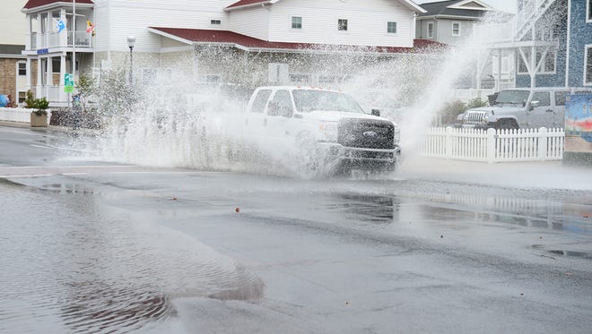 A truck goes through some roadway flooding on South Philadelphia Avenue in Ocean City, Md., as Hurricane Jose passes off the Atlantic Coast on Tuesday, Sept. 19, 2017.