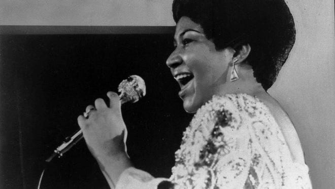 Vocalist Aretha Franklin warbles a few notes into microphone in January 1972.