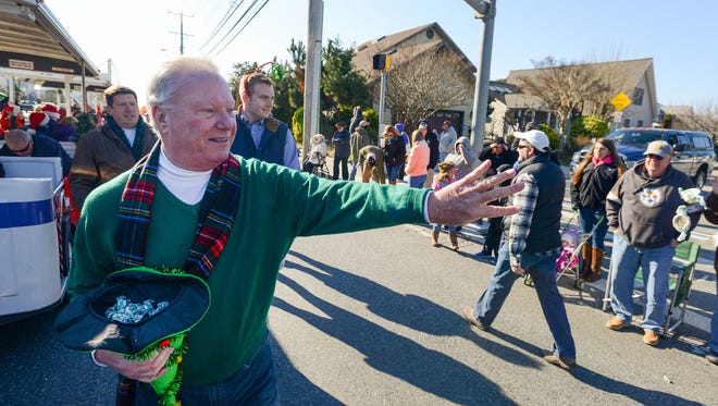 In this Daily Times file photo, Ocean City Mayor Rick Meehan throws candy to the crowds lined up along Coastal Highway during the 2015 Christmas parade.