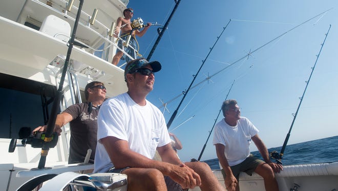 "If you go into this to win, and expect to win, you better not fish. It's got to be for the love of the sport," said John Kunzler, right, owner of the boat "Chasin Tails." Kunzler, along with, from foreground clockwise: Mike Waldhauser, Buddy Trala and Andrew Dietz were part of the crew on Kunzler's boat hoping to win big money during the White Marlin Open in Ocean City, Maryland.