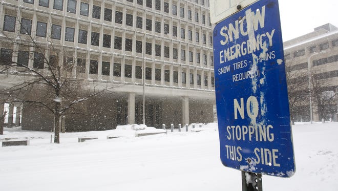 A sign hardly seems necessary on lonely King Street opposite the J. Caleb Boggs Federal Building as snow continues to fall in Wilmington early Saturday afternoon, Feb. 6, 2010.
