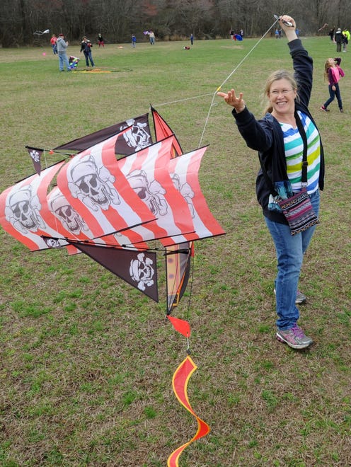 Nancy Forsyth from Lewes tries to get her pirate kite airborne as despite cloudy and rainy weather, the 48th Annual Kite Festival was held on Friday March 25th at Cape Henlopen State Park near Lewes with a good crowd on hand flying all kinds of kites and creations.