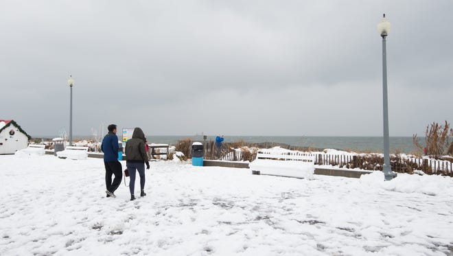 Visitors walk on the snow covered boardwalk at Rehoboth Beach.