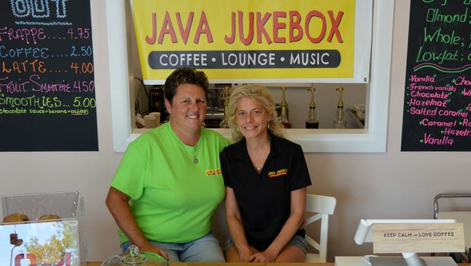 Nan and Kris Martino smile behind the counter at their new coffee shop, Java Jukebox, in Rehoboth Beach.