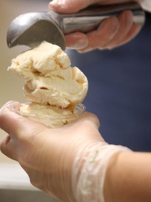 A cup of ice cream is stacked high at the UDairy Creamery.