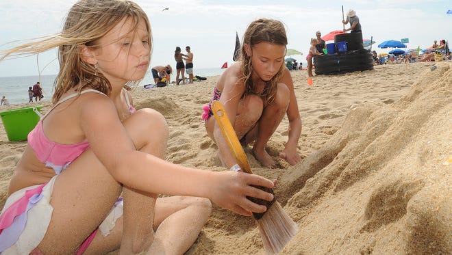 Left to right: 7-year-old Lacey Ferrell and her friend Lily Boyer, 12, both from Middletown, work to create a mermaid at the 38th Annual Rehoboth Beach-Dewey Beach Chamber of Commerce Sandcastle Contest.