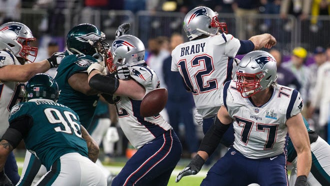 Brandon Graham, second from left, forces Patriots quarterback Tom Brady to fumble the ball in the Eagles' 41-33 win in the Super Bowl on Feb. 4. Graham revealed Thursday that he played that game with a high ankle sprain.