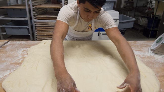 Wilson Ramirez, a baker at Old World Breads in Lewes, prepares the dough to be cut into smaller sizes.
