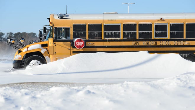Cape Henlopen School District School buses are covered with snow and ice circles after the blizzard on Friday, Jan. 5, 2018.