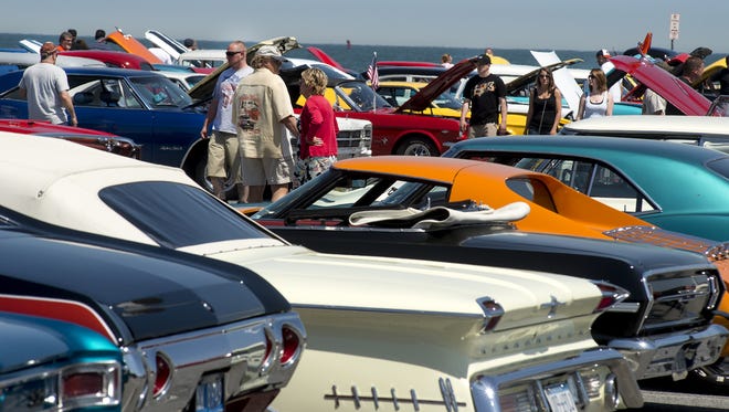 Car enthusiasts walk around Inlet Lot in Ocean City checking out all the cars on display during Cruisin' Ocean City.