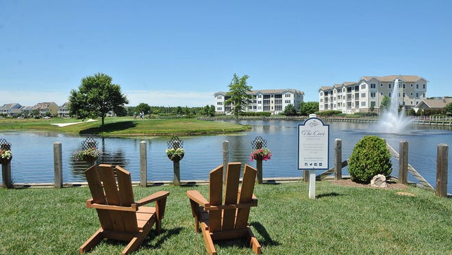 Chairs located at the club house at the Bayside Resort Golf Club in Selbyville overlook the 18th hole surrounded by the pond.