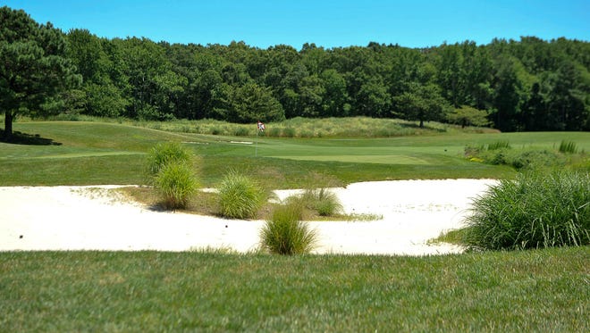 Rolling hills and dunes highlight the ninth hole on the Kodiak 9 hole course at Bear Trap Dunes in Ocean View on July 11.