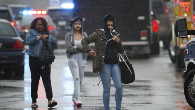 Two students and a mother leave Great Mills High School, the scene of a shooting, March 20, 2018 in Great Mills, Md. The shooting left at least three people injured including the shooter.
