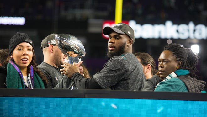 Eagles running back and Wilmington native Wendell Smallwood holds the Vince Lombardi Trophy Sunday at US Bank Stadium.