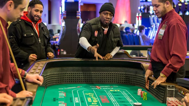 Mike Brown plays craps at Dover Downs Casino earlier this month.