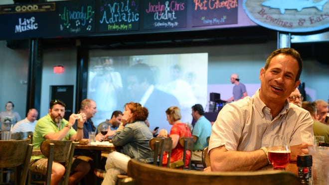 Sam Calagione, founder of Dogfish Head Craft Brewery and a 2017 James Beard Award winner, enjoys a brew at his new restaurant Dogfish Head Brewings & Eats in Rehoboth Beach. The $4 million eatery has replaced the old building on Rehoboth Avenue.