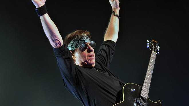 Pick in hand, snakeskin do-rag wrapped around his head, George Thorogood greets a full Grand Opera
house in 2009.