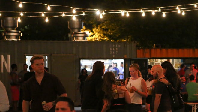 People relax during the first night of the Constitution Yards beer garden at the Wilmington Riverfront Friday.
