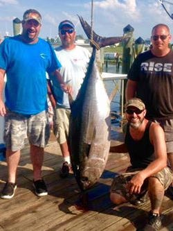 Lindsay Price, Jim Azato, Jason Lesniczak and Jim Tolson stand next to a 162-pound big eye tuna that they caught at the Baltimore Canyon.
