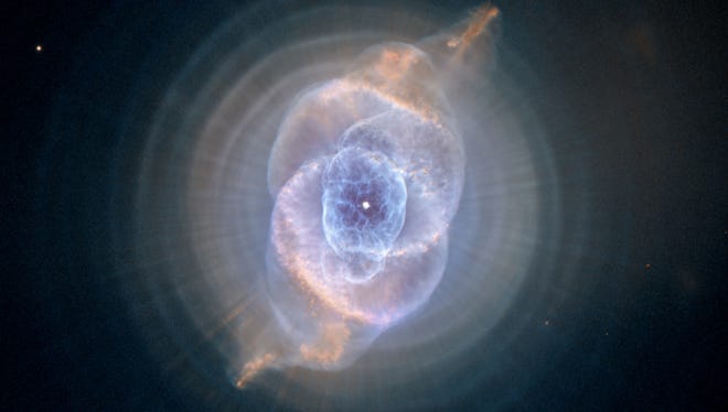This image made by the NASA/ESA Hubble Space Telescope shows NGC 6543, the Cat's Eye Nebula. A planetary nebula forms when Sun-like stars gently eject their outer gaseous layers that form bright nebulae. In 1994, Hubble first revealed the nebula's surprisingly intricate structures, including concentric gas shells, jets of high-speed gas, and unusual shock-induced knots of gas. The Hubble Space Telescope marks its 25th anniversary. A full decade in the making, Hubble rocketed into orbit on April 24, 1990, aboard space shuttle Discovery.  (NASA, ESA, HEIC, Hubble Heritage Team (STScI/AURA) via AP) ORG XMIT: NY926