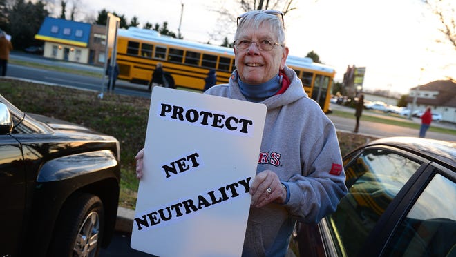 Betty Deacon, 73, Lewes, came out to protest the vote next week where the Federal Communications Commission could change the way Delmarva residents, and the nation, use the internet. Thursday, Dec. 7, 2017.