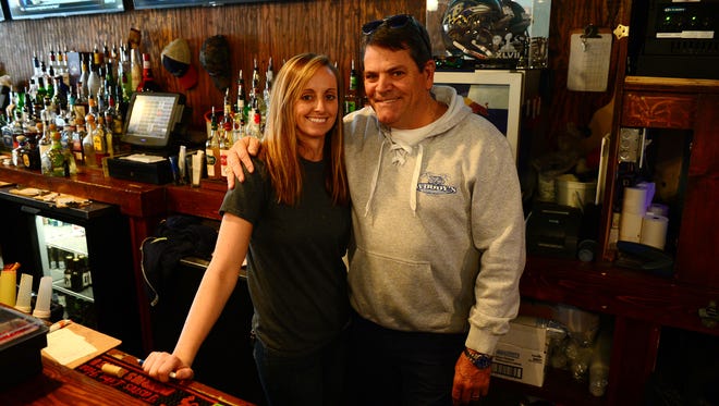 Woody’s Bartender Kasey O’Brien and Jimmy O’Conor, Owner, pose for a photo on Tuesday, Dec. 12, 2017.