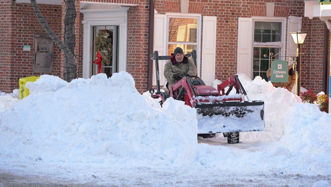 A man plows the sidewalk in downtown Lewes on Friday, Jan. 5, 2018.