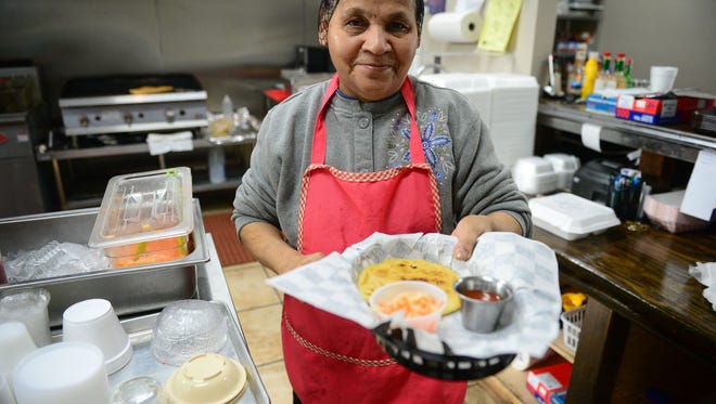 Maria Gomez serves a pupusa at Dona Maria Pupuseria on Wednesday, Jan. 10, 2018 in Seaford, Del.