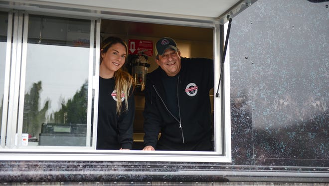 Sarah King, Manager, and Mike LaPenta, Owner of Casapulla's Subs in Rehoboth pose for a photo in there new food truck "Big Salami" on Monday, Jan. 29, 2018.