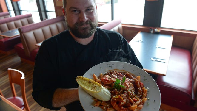 Albertino's Head Chef Jeremiah Hart, holds a seafood and homemade pasta dish on Wednesday, Feb. 28, 2018.