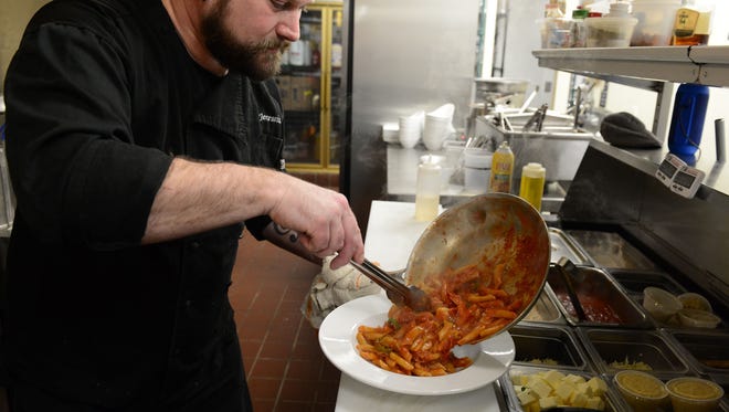 Albertino's Head Chef Jeremiah Hart, prepares a seafood and homemade pasta dish on Wednesday, Feb. 28, 2018.