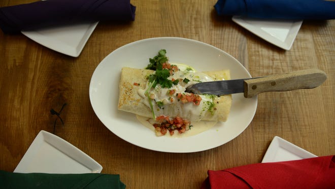 Bayside Cantina's Surf & Turf Burrito- Tender shrimp, sliced steak, pico de Gallo, quest, cantina beans & rice, rolled & griddled.
