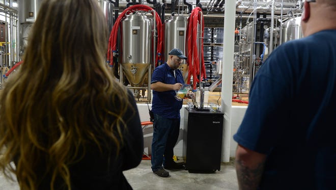 Lars Ryan, Off-Centered Experience Ambassador, leads a group through the new distillery tour at the Dogfish Head Milton Brewery and Distillery on Wednesday, May 16, 2018.