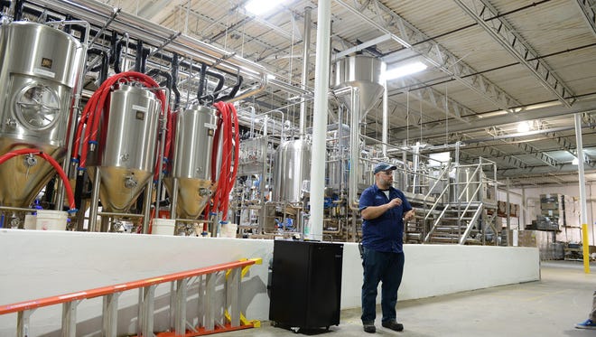 Lars Ryan, Off-Centered Experience Ambassador, leads a group through the new distillery tour at the Dogfish Head Milton Brewery and Distillery on Wednesday, May 16, 2018.