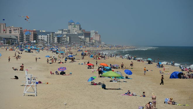 In this file photo, Umbrellas and crowds are starting to cover the beach on this Memorial Day weekend in Ocean City, Md. on Friday, May 25, 2018.