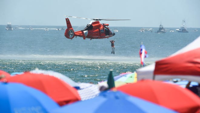 The USCG Search and Rescue performs a demonstration during the 2018 Ocean City Air Show on Saturday, June 16, 2018