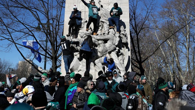 PHILADELPHIA, PA - FEBRUARY 08: Fans celebrate with the Philadelphia Eagles during their NFL Super Bowl victory parade on February 8, 2018 in Philadelphia, Pennsylvania. The Philadelphia Eagles defeated the New England Patriots in Super Bowl LII to win their first Super Bowl in franchise history. (Photo by Patrick Smith/Getty Images)