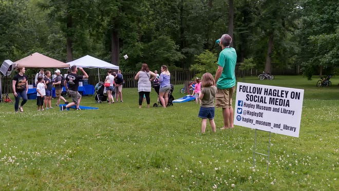People stopped to grab a beer or play cornhole during Hagley Museum's Bike & Hike event Wednesday evening.