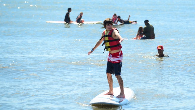 Keith Cranska, 20, Glennwood, Md. catches a wave during the Surfers healing tour that helps people living with autism by exposing them to a surfing experience in Ocean City. on August 17, 2016.