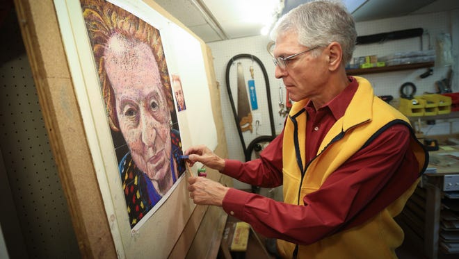 Paul Simon, a recently retired scientist, works on a current pastel  portrait of woman whom he met through Jewish Family Services where he volunteers to driving seniors to needed places.