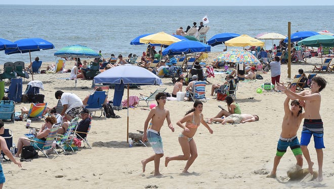 Cool weather keeps visitors out of the water in Rehoboth Beach as the Memorial Day weekend starts the summer season with a large crowd on the beach and boardwalk on Sunday, May 28, 2017.