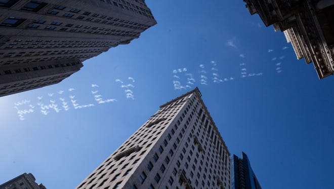 Skywriting planes spell out Philly Dilly above the Super Bowl LII Championship parade route.